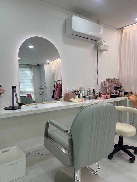 Professional consultation station with arched backlit mirror and mint green salon chair