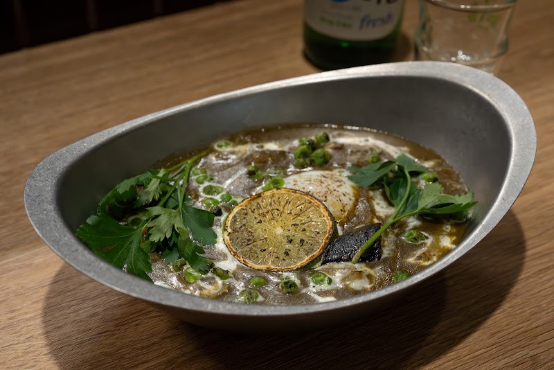 Savory kitchen specialty with seared citrus garnish and herbs
