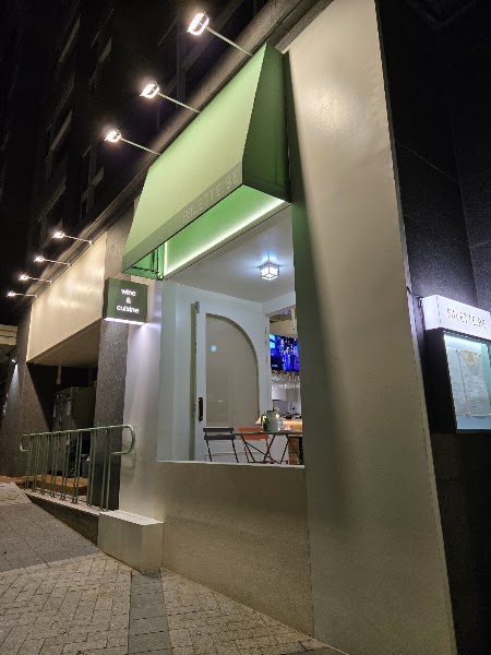 Night exterior view of PALETTE.BE storefront with illuminated signage and green awning in Yongsan
