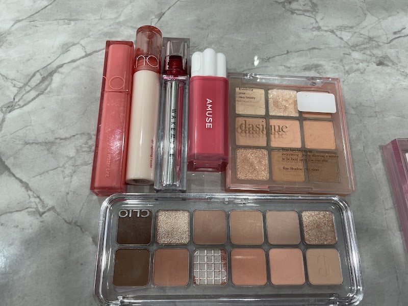 Curated eyeshadow palettes and lip tints arranged for cosmetic tone testing
