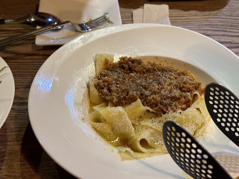 Pappardelle pasta with rich meat ragù sauce and freshly shaved parmesan cheese at Andante Vino