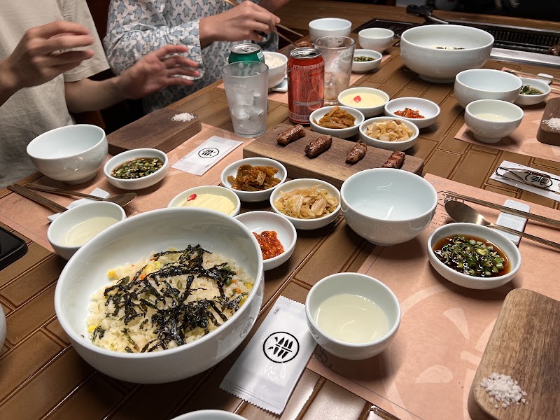 Full table spread of Korean barbecue and traditional sides