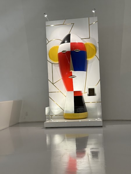 Stylized abstract sculpture with geometric color blocks displayed inside Dongdaemun Design Plaza
