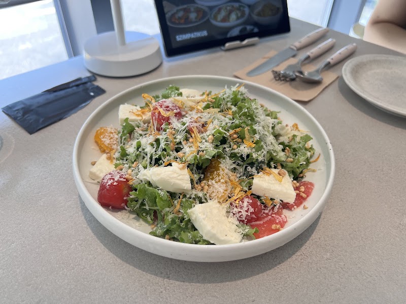 Fresh garden salad with mixed greens, mozzarella pearls, and ripe cherry tomatoes