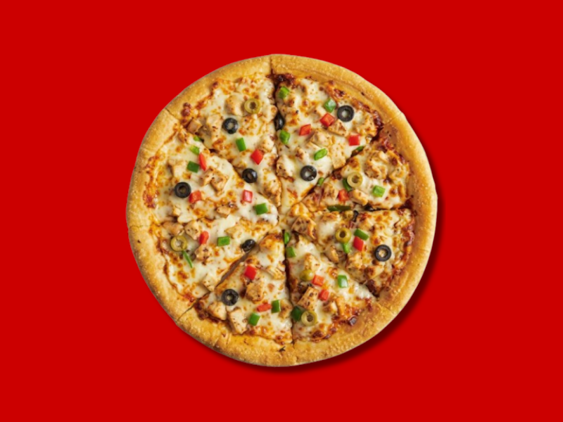 A round sliced pizza with chicken, black olives, and green and red peppers on a solid red background.