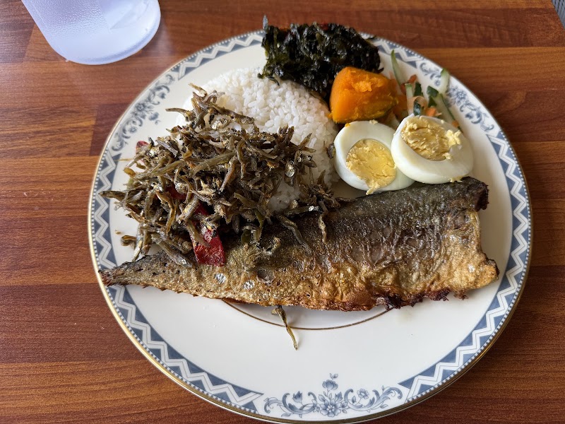 Home-style cooked fish served with white rice and side vegetables