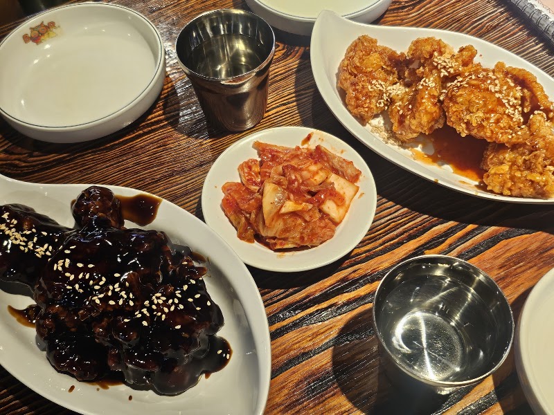 Crispy glazed fried chicken dishes with sesame seeds on dining table