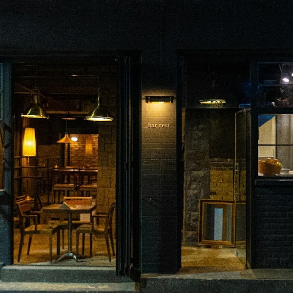Exterior entrance of Leseuteu wine bar illuminated at night