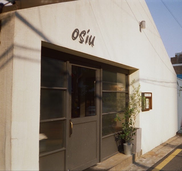 Exterior facade of Osiu wine bar in Yongsan with textured walls and dark entrance