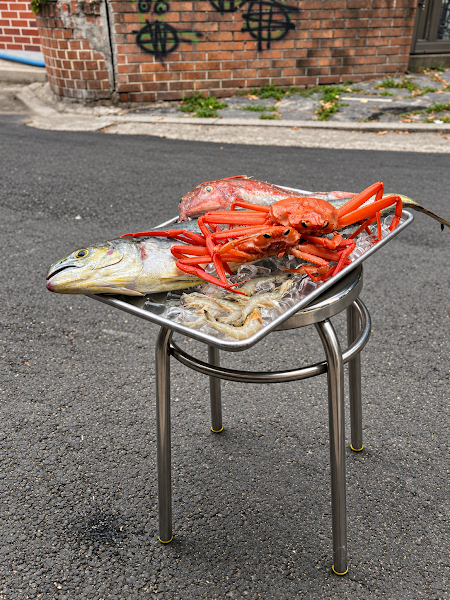 Fresh seafood selection displayed in a metal ice tray on the street
