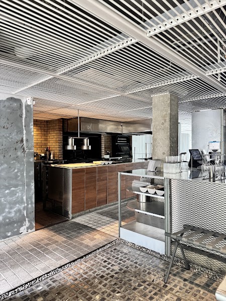 Industrial interior service counter with steel mesh and grid ceiling details