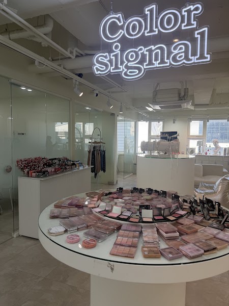 Bright interior of Color Signal beauty studio with cosmetic display tables