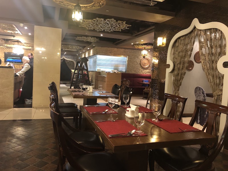 Interior of Saffron Halal restaurant in Seoul with warm lighting, wooden tables, and red placemats