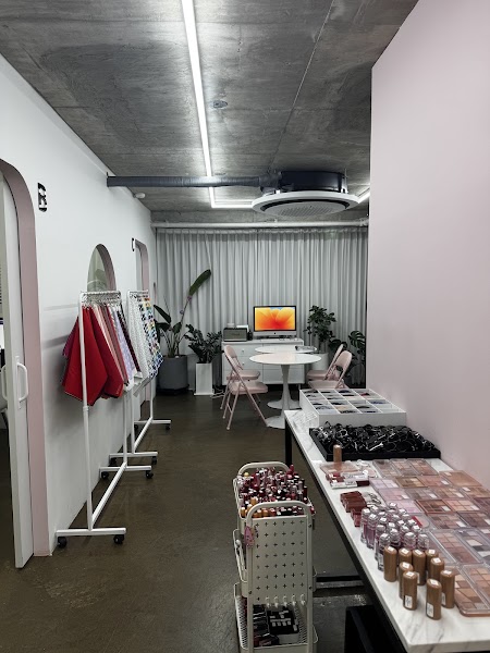 Consultation room interior with cosmetic display table and client workstations