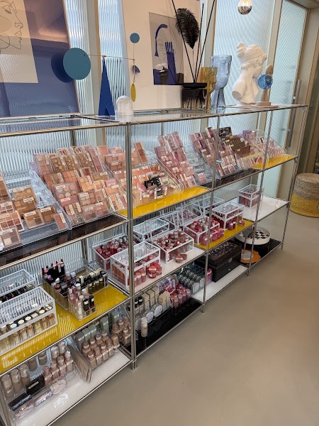 Organized cosmetics shelving unit with foundation and makeup palettes