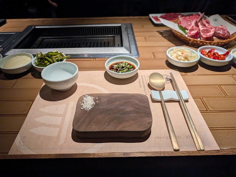 Sophisticated table setting with brass utensils and side dishes