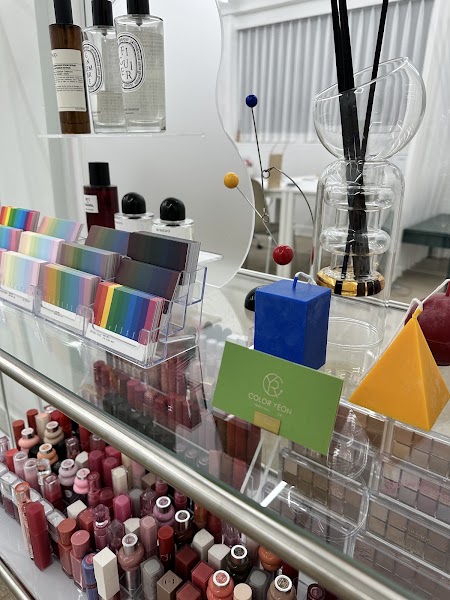 A tidy studio shelf display at Coloryeon featuring color palette cards and cosmetic lip products.