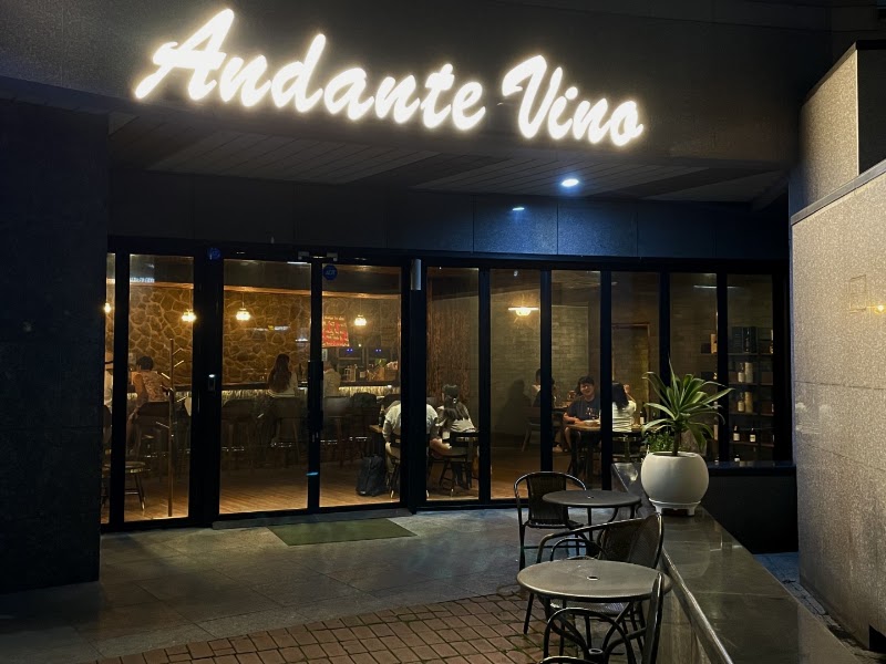Warm evening storefront of Andante Vino at Gongdeok Pentraus with glowing sign and glass facade