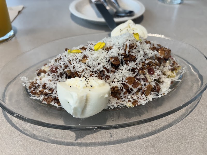 Savory cabbage salad with toasted granola, shaved cheese, and boiled egg