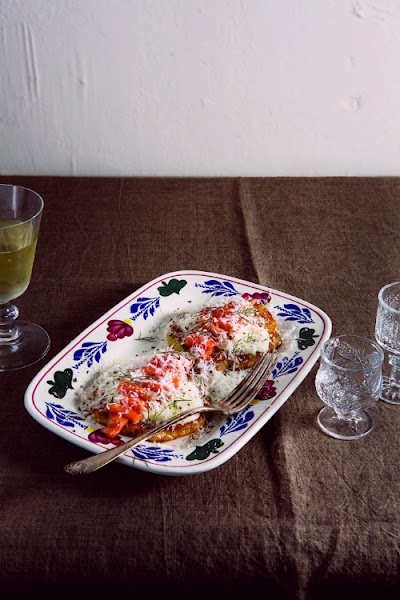 Table setting with wine glass and patterned porcelain plates at Seoul'n'Soul