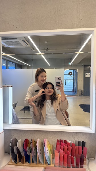 People taking a mirror selfie in a professional color consultation studio.