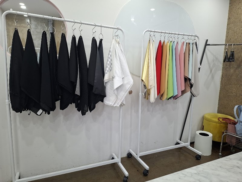 Rolling racks holding solid and patterned fabric swatches for undertone analysis