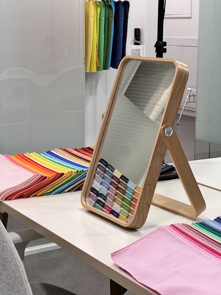 Desk mirror reflecting colored fabric draping swatches