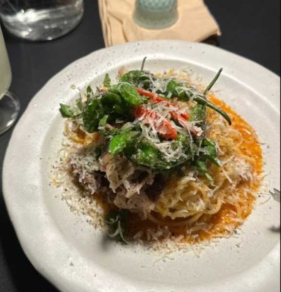 Fusion pasta topped with shishito peppers and cheese
