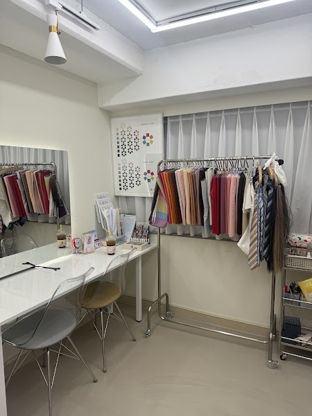 Consultation desk and textile drape rack with color theory chart.