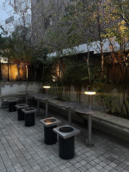 Intimate outdoor terrace with modern metallic tables and warm lighting