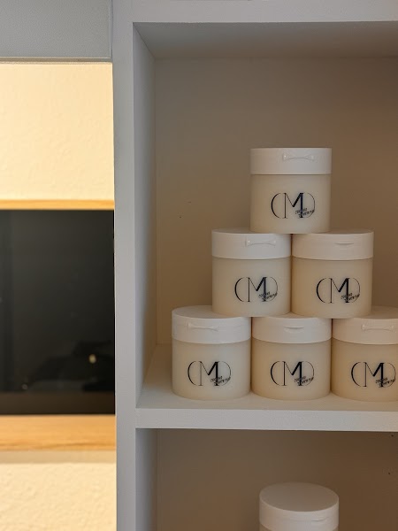 Stack of cosmetic jars on white studio shelving