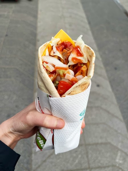 Freshly wrapped warm kebab in hand