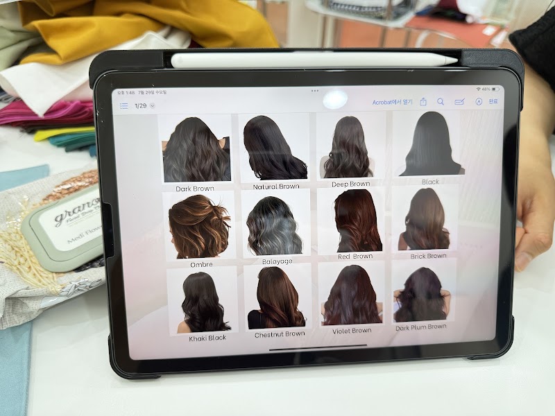 Tablet displaying a comprehensive hair color shade reference chart during consultation session