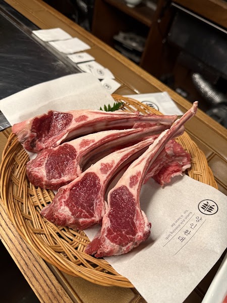 Premium raw lamb chops in a woven basket