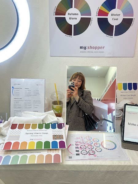 Personal color analysis consultation table with color wheels, reference cards, and mirror