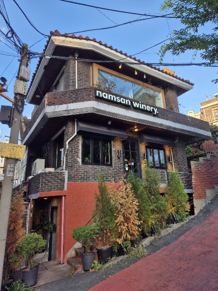 Exterior brick facade of Namsan Winery on a hillside street in Yongsan District