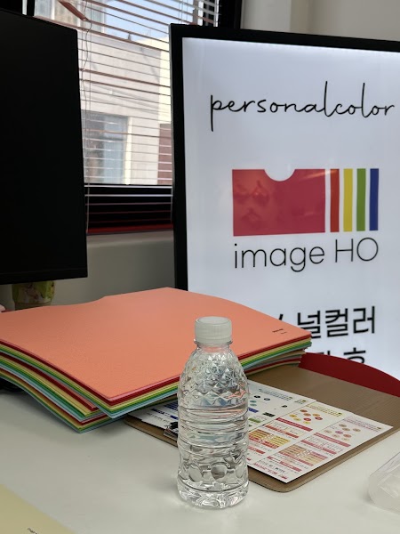 Desk with stacked colored paper folders, chart clipboard, and Image HO branding