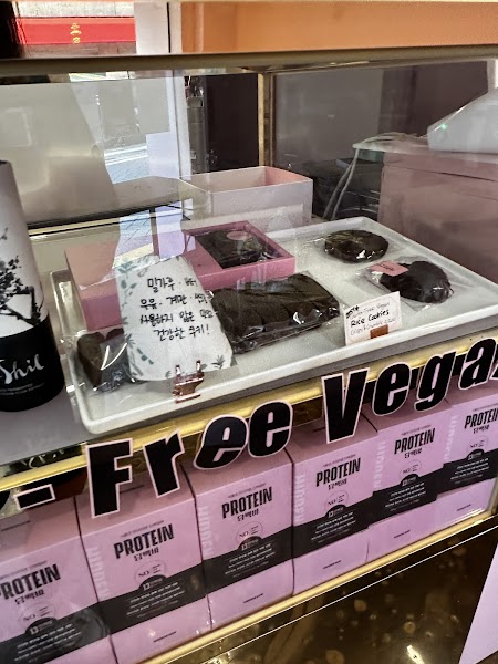 Display case at Hidden Gem chocolate shop containing packaged vegan treats and cookies