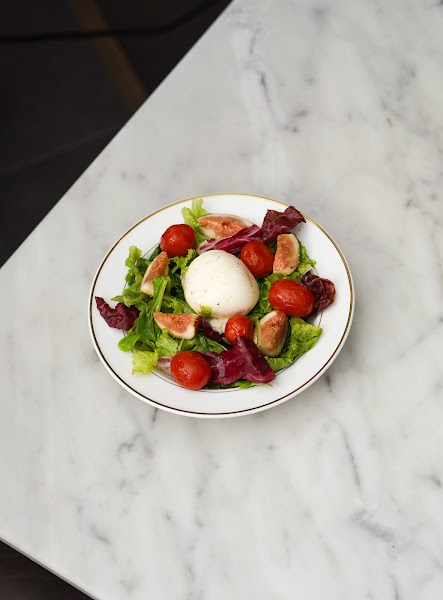Fresh salad with burrata, halved figs, and crisp seasonal greens
