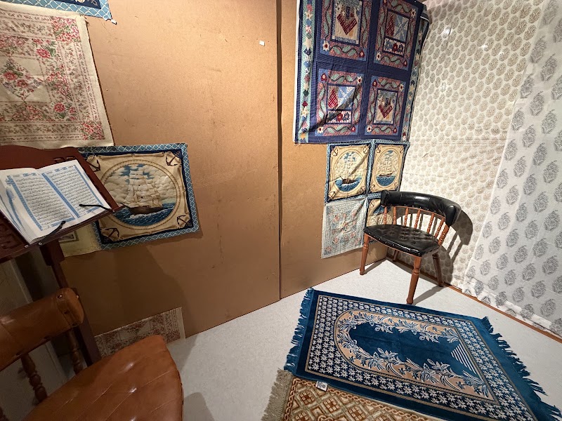 Dedicated prayer room with clean rugs and Quran stand at Cherry Garden Restaurant