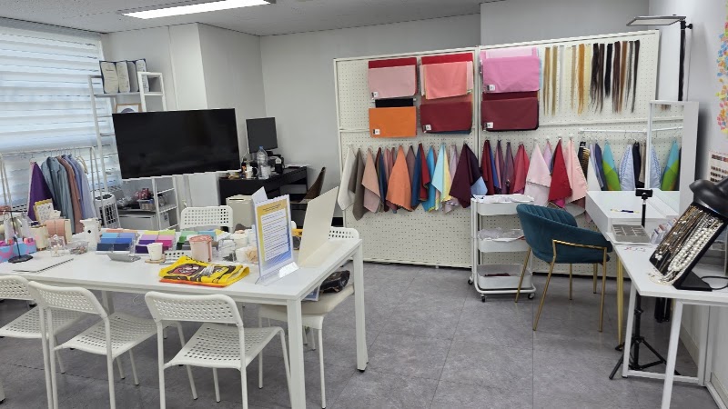 An interior shot of a colorful personal color consultation studio with fabric swatches on display.