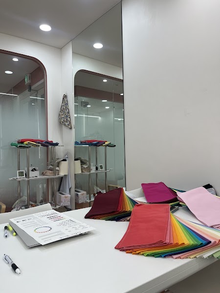Personal color analysis workstation with fabric swatches, color consultation chart, and large studio mirror