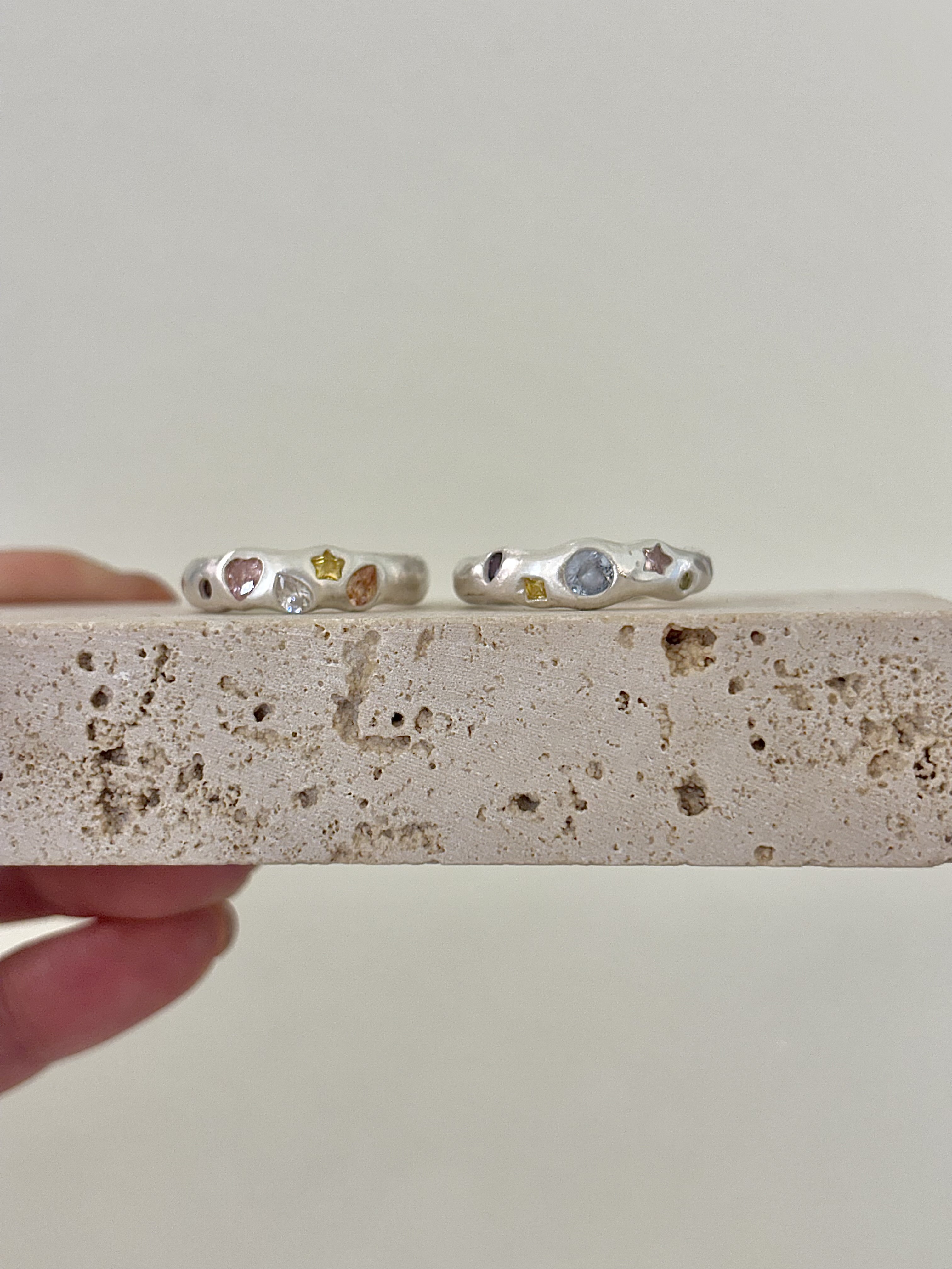 Basic silver ring crafted with gemstone settings and custom engravings