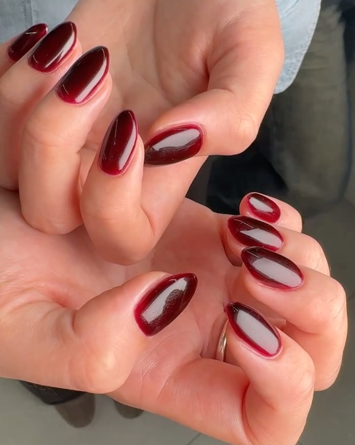Deep red almond-shaped gel manicure with high-gloss finish