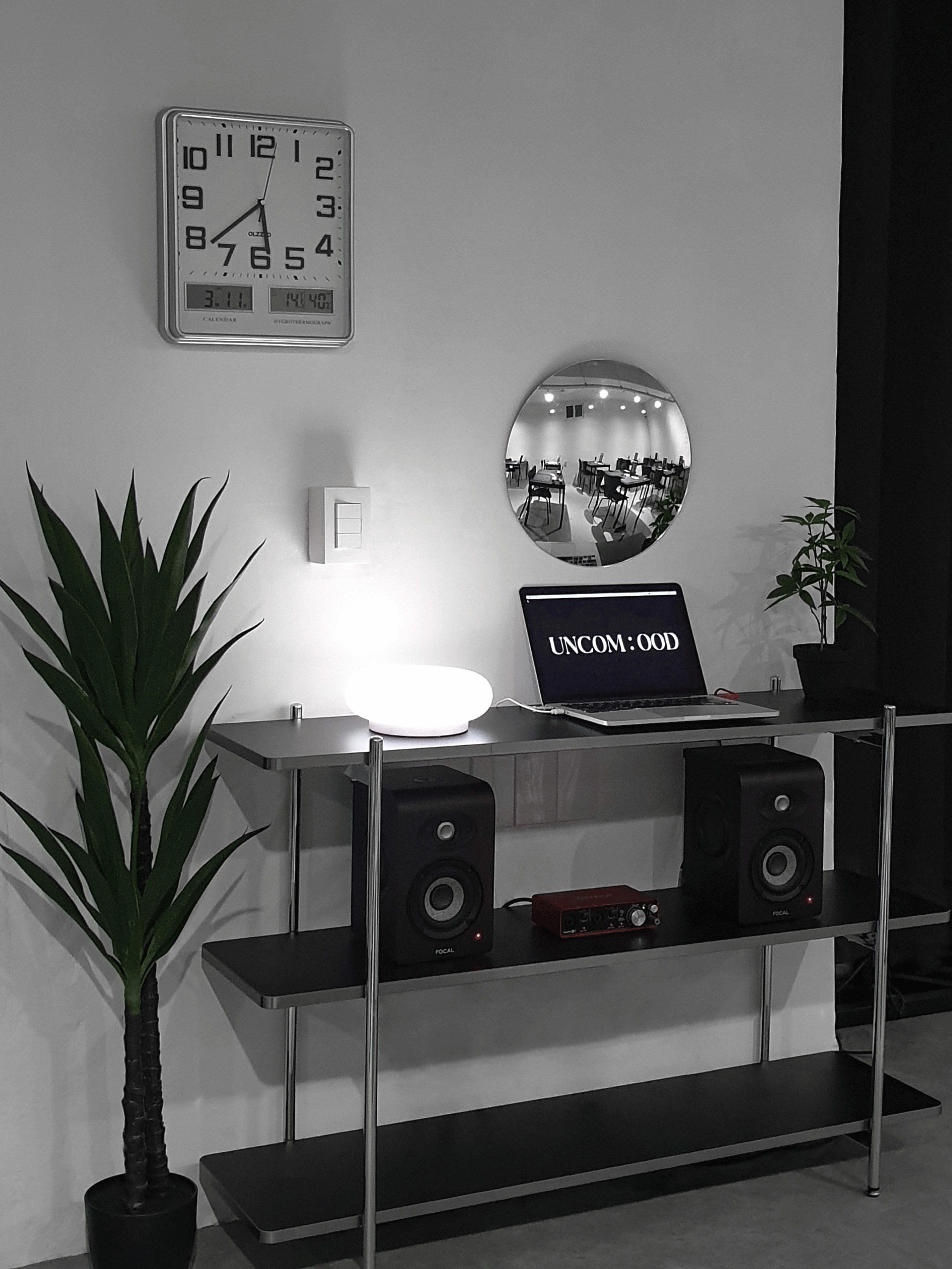 Workbench and UNCOMOOD sign inside the Seongsu studio