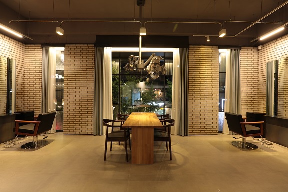 Architectural salon interior with brick walls and styling mirrors