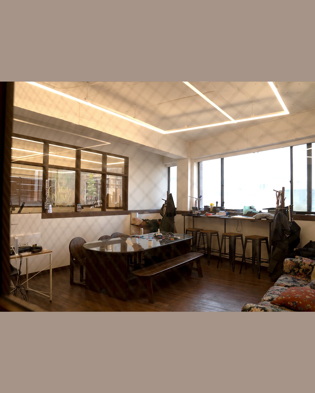 Consultation lounge and natural light hospitality area inside Ape Ink Studio