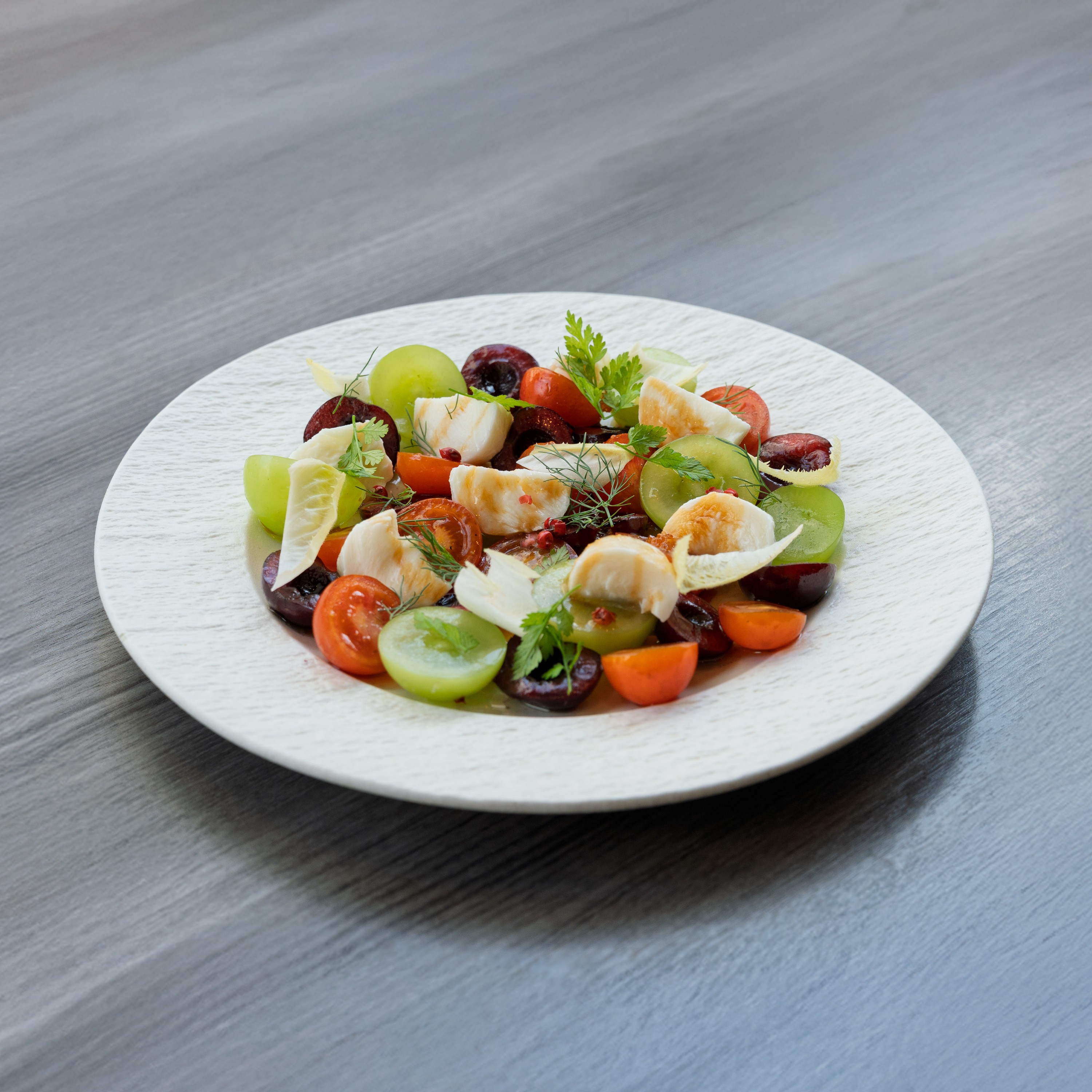 Seasonal fruit, heirloom cherry tomatoes, and fresh burrata salad