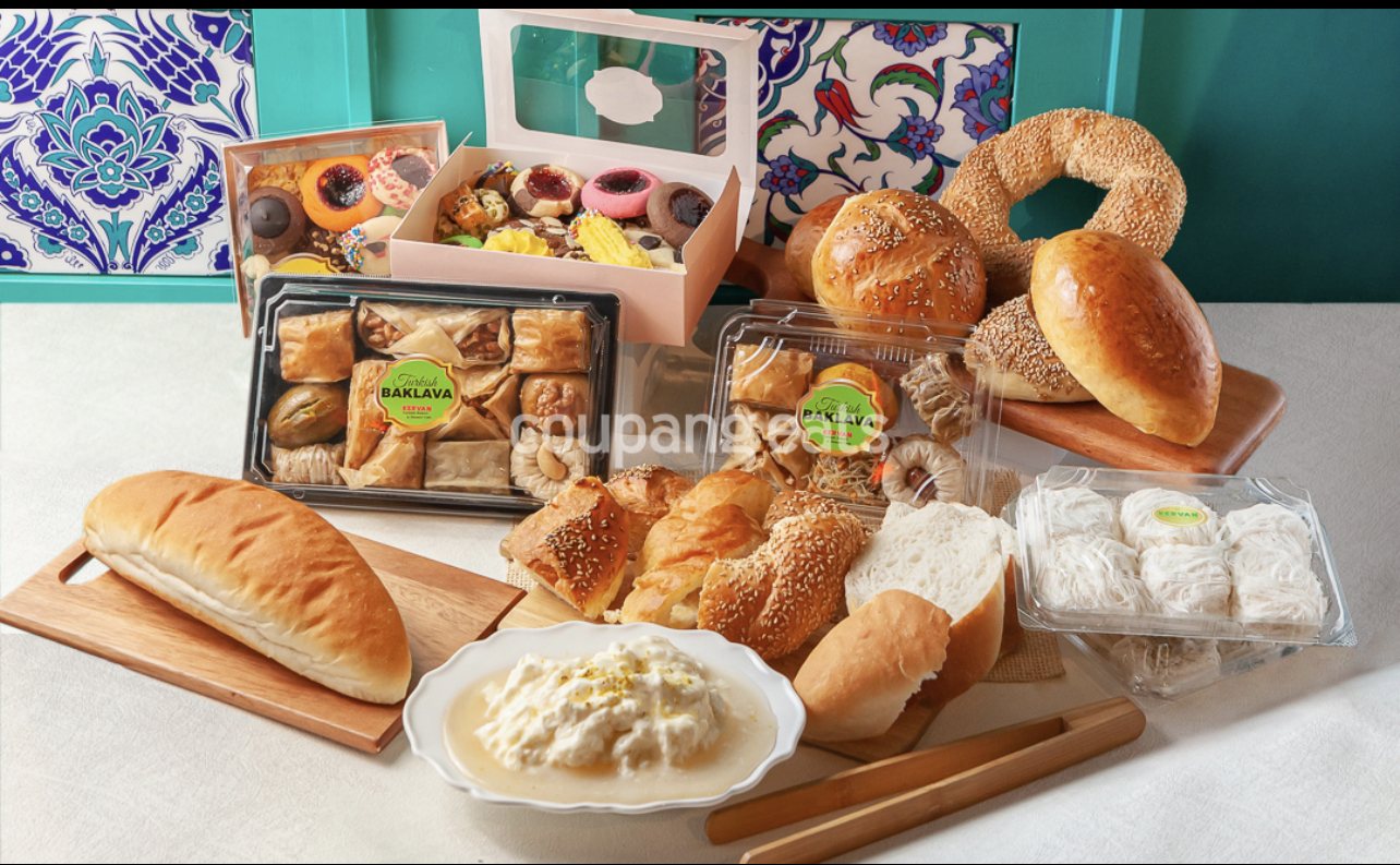 Assortment of Turkish breads, cookies, and packaged baklava on a table