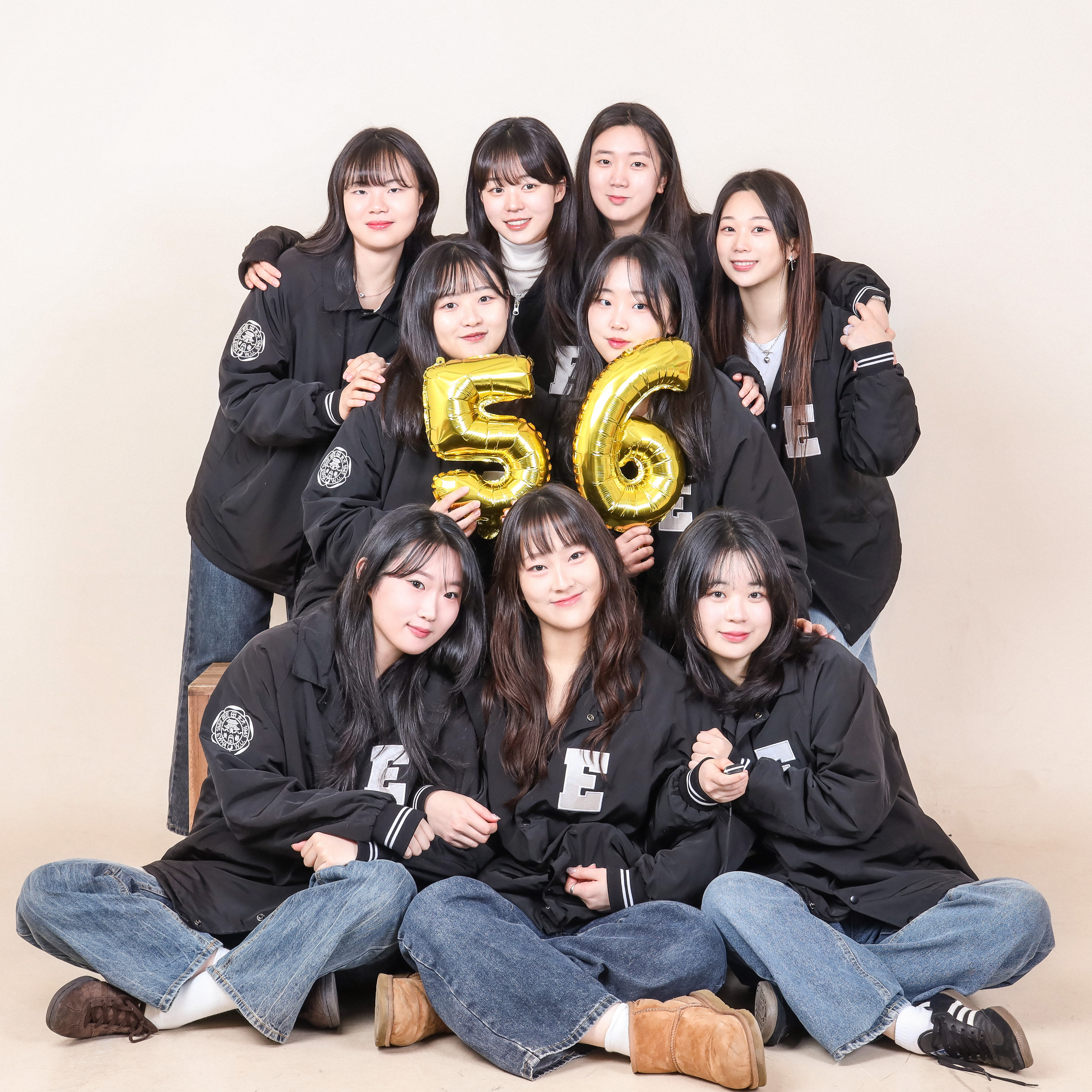 Large group of women in matching black jackets